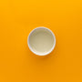 White cup on an orange background