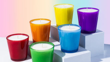 Set of colorful candles on a gradient background