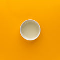 White cup on an orange background