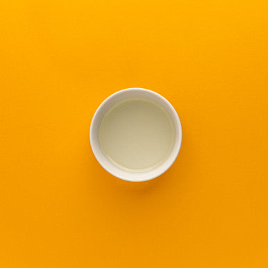 White cup on an orange background