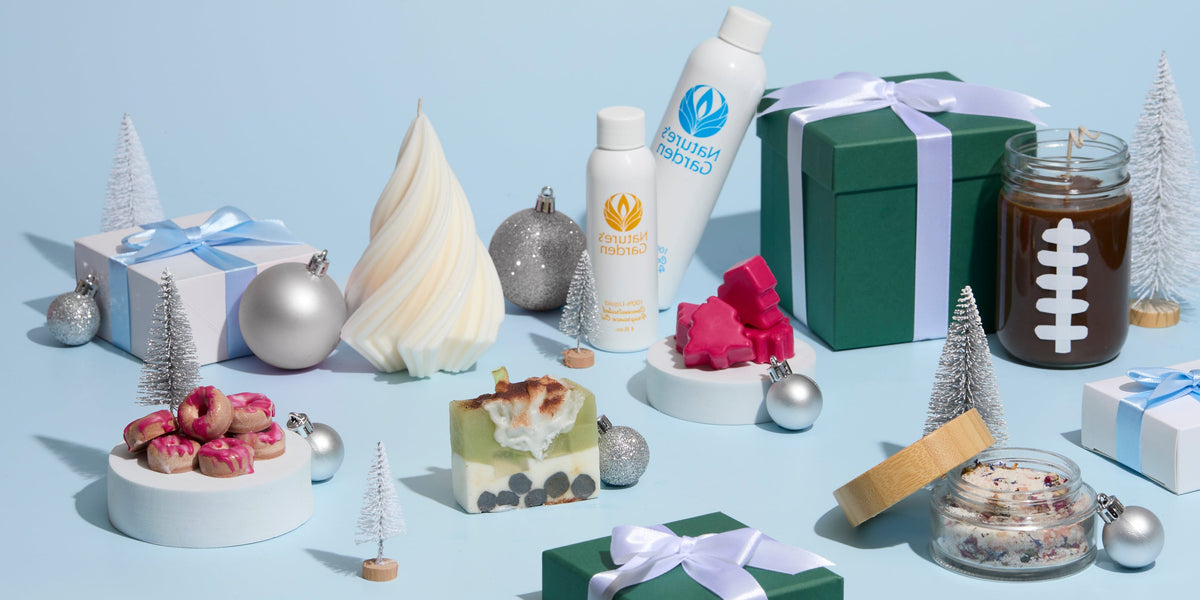 Nature’s Garden holiday display with candles, soap, bath products, wrapped gifts, silver ornaments, and miniature trees on a light blue background.