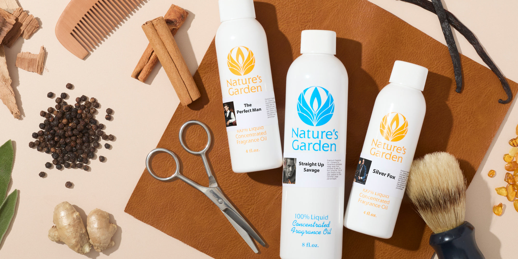 Flat lay of Nature’s Garden fragrance oil bottles with barber tools, including scissors, shaving brush, comb, cinnamon sticks, vanilla beans, peppercorns, and ginger on a leather surface.