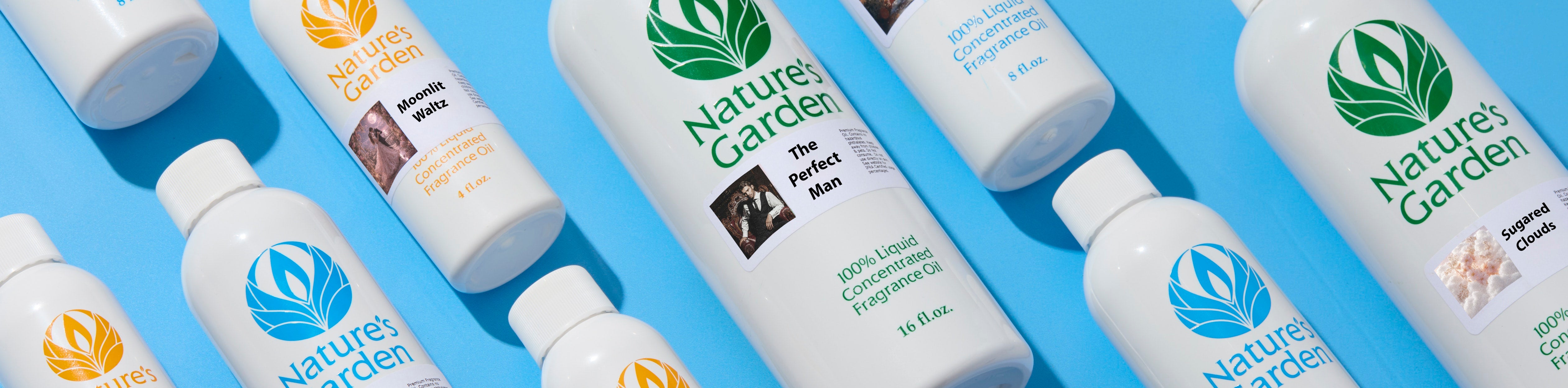 Nature’s Garden fragrance oil bottles arranged diagonally on a bright blue background, featuring scents including The Perfect Man, Moonlit Waltz, and Sugared Clouds.